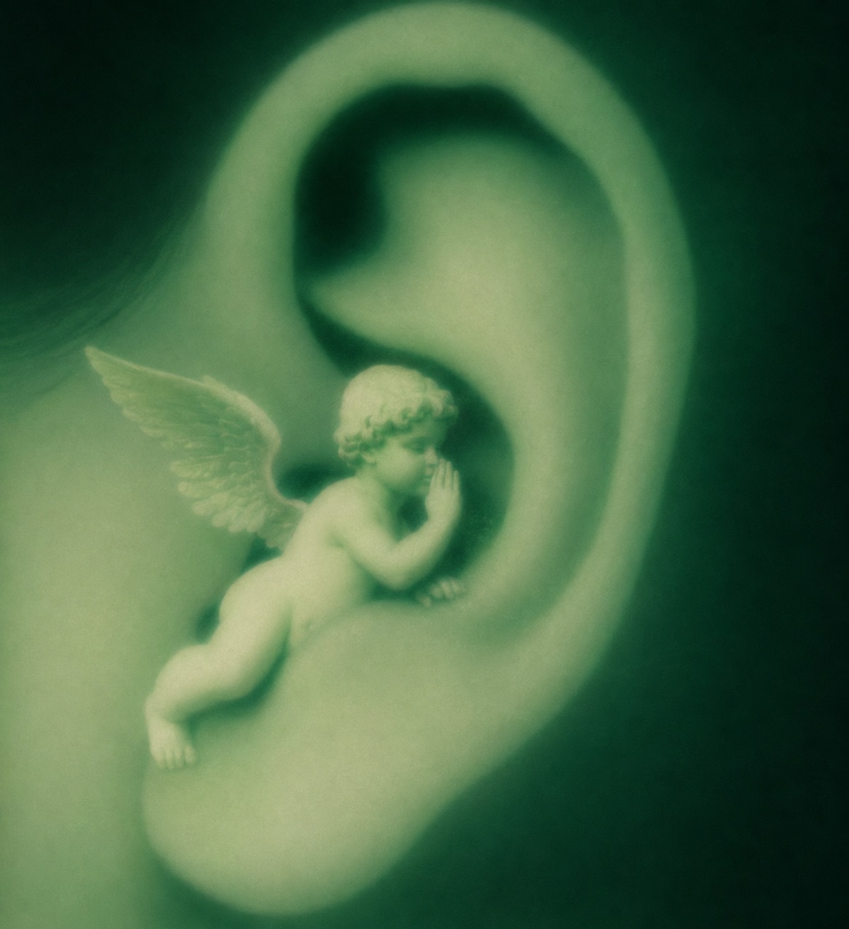 A soft-focus ear, tinted green, with a small winged figure whispering into it